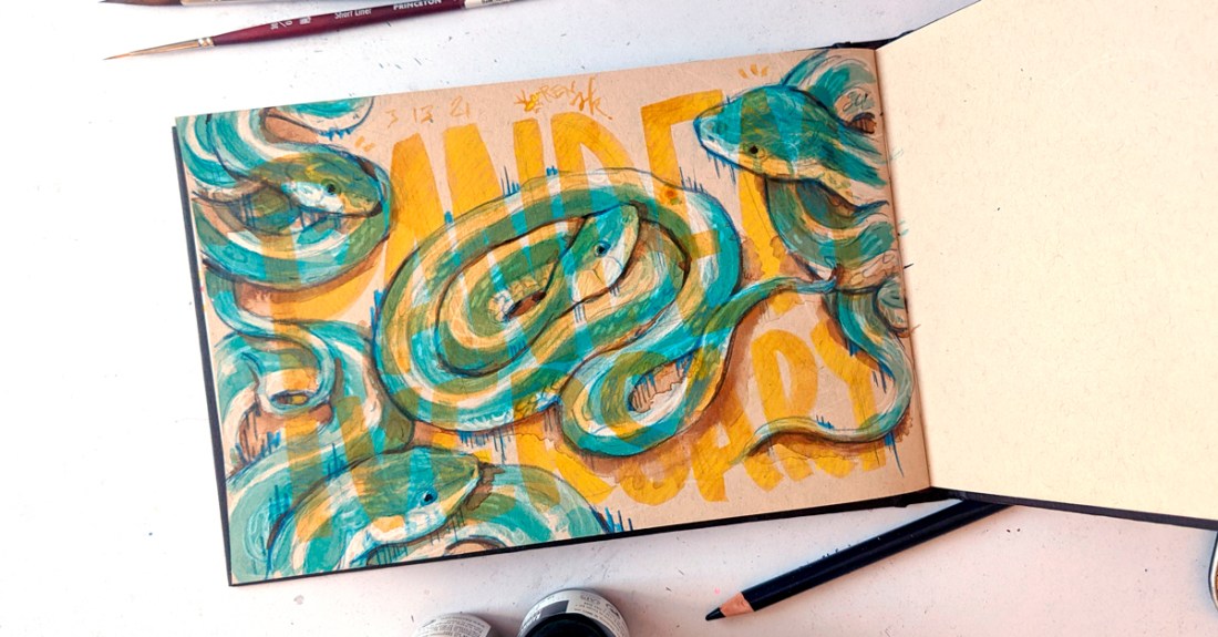 Sketchbook open to a drawing of four garner snakes in colored pencil and ink. Hand-lettering over it in transparent ochre ink says "PANDEMIVERSARY"