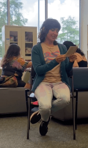 Screenshot of the artist reading from a poetry zine at the public library